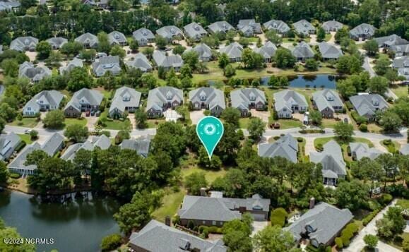 drone / aerial view with a water view and a residential view