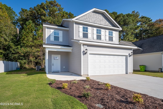 view of front facade featuring a front yard and a garage