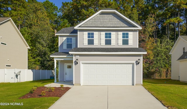 view of front of home featuring a front lawn and a garage