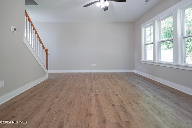 unfurnished room with hardwood / wood-style flooring and ceiling fan