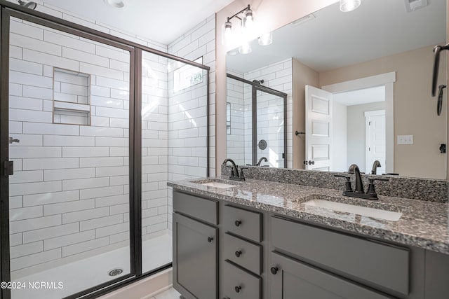 bathroom featuring vanity and a shower with door