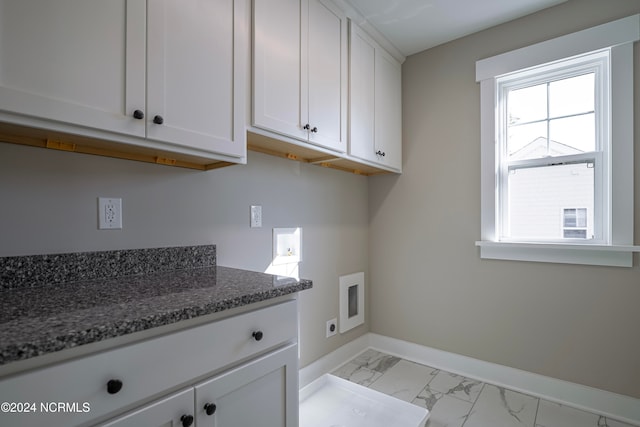 washroom with hookup for an electric dryer, washer hookup, and cabinets