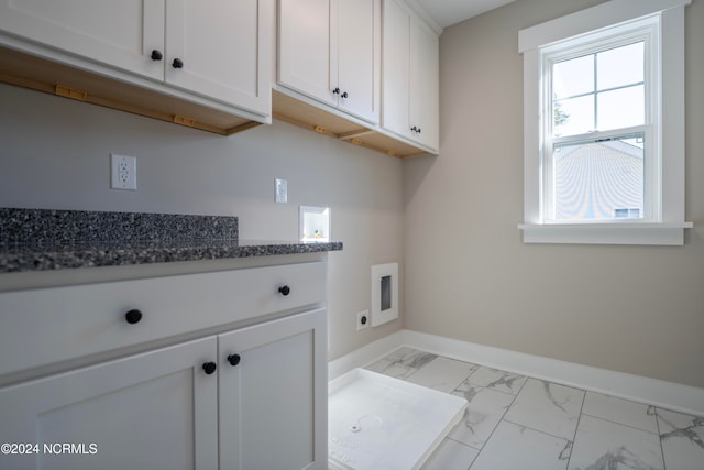 washroom featuring cabinets, hookup for an electric dryer, and hookup for a washing machine