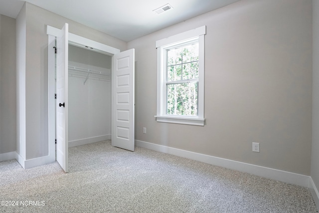 unfurnished bedroom featuring a closet and carpet flooring