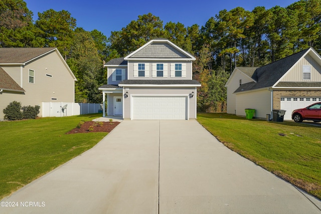 view of front of property with a front lawn and a garage