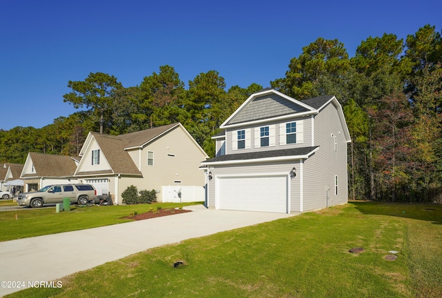 view of property featuring a front yard and a garage