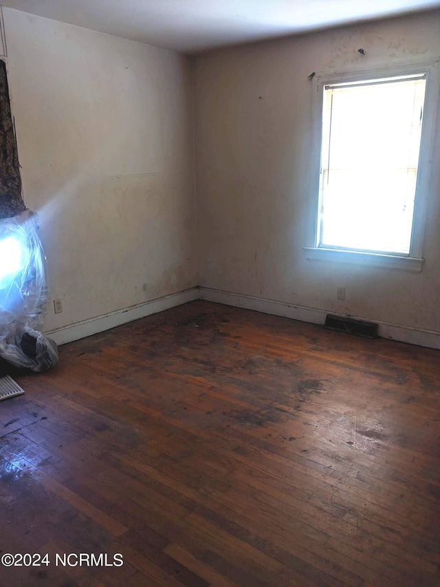 spare room with dark wood-type flooring