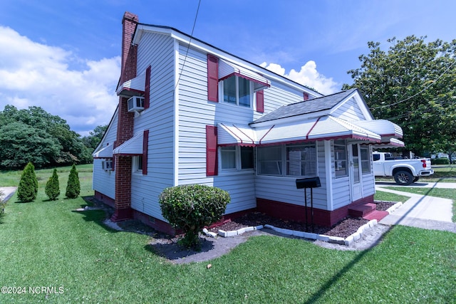 view of property exterior featuring a lawn and cooling unit