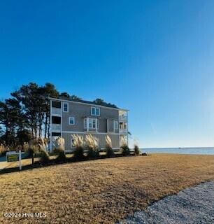 view of front of property with a water view