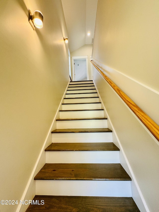 staircase with vaulted ceiling