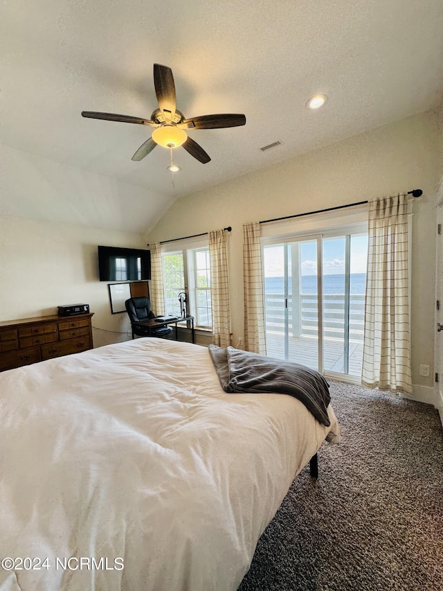 bedroom featuring lofted ceiling, ceiling fan, access to exterior, a textured ceiling, and carpet floors