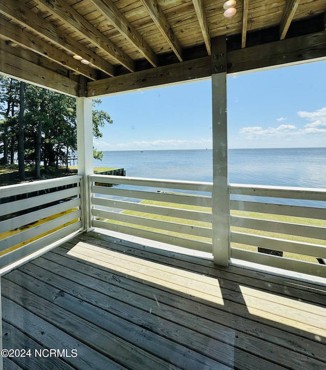 wooden terrace featuring a water view