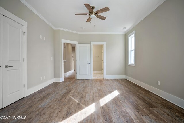 unfurnished bedroom with ornamental molding, a closet, ceiling fan, and hardwood / wood-style floors