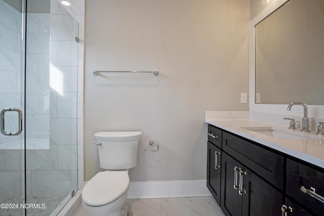 bathroom featuring tile flooring, oversized vanity, toilet, and a shower with door