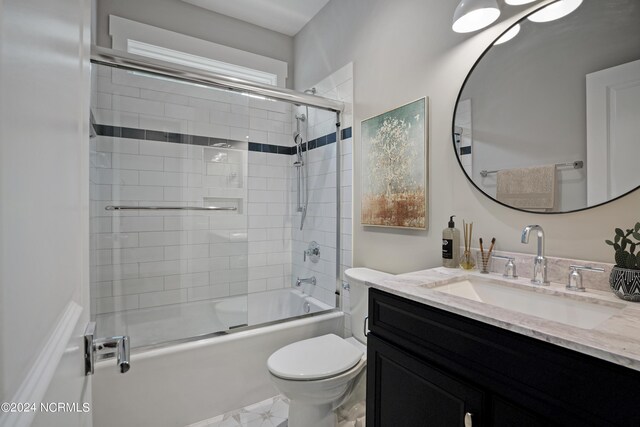 full bathroom featuring tile floors, bath / shower combo with glass door, toilet, and vanity