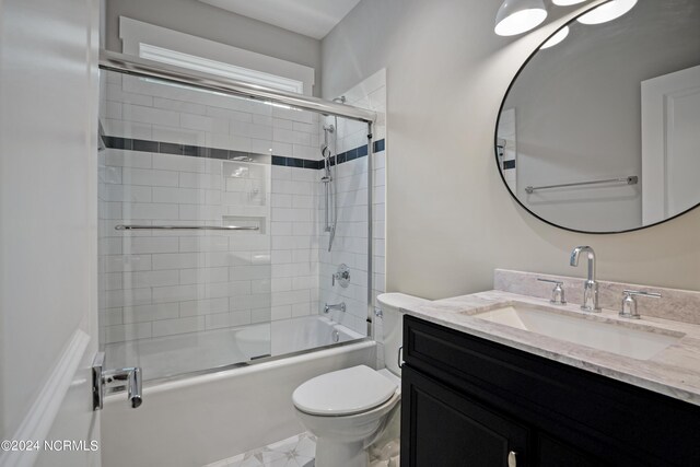 full bathroom featuring tile flooring, combined bath / shower with glass door, toilet, and vanity