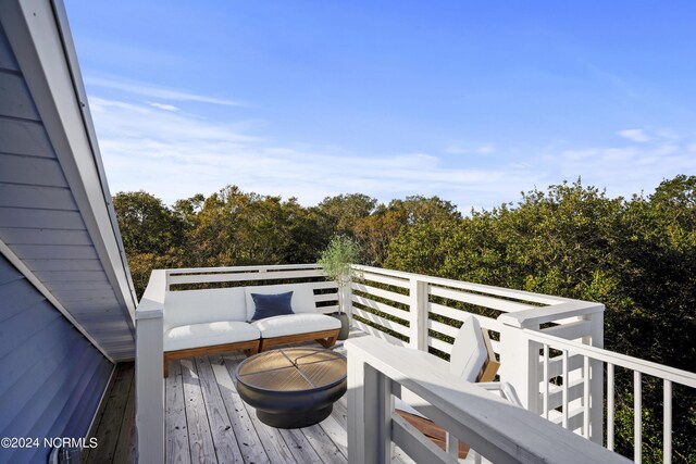 wooden deck with an outdoor living space