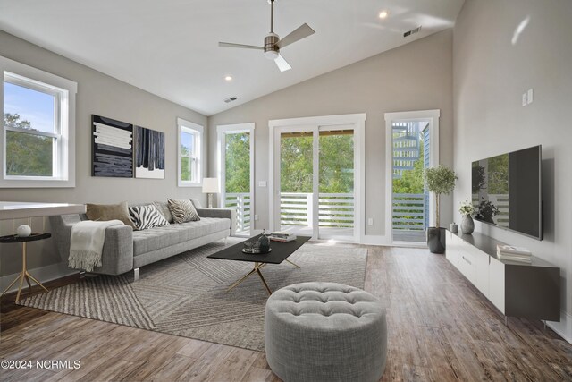 living room featuring a healthy amount of sunlight, wood-type flooring, and ceiling fan