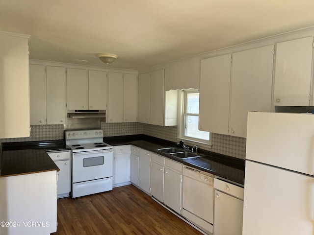 kitchen with white appliances, decorative backsplash, dark countertops, under cabinet range hood, and a sink