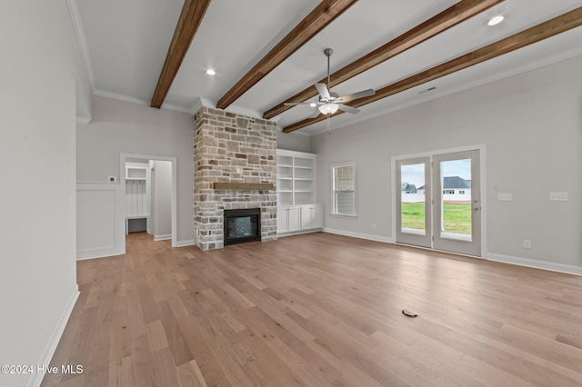 unfurnished living room featuring a fireplace, light wood-type flooring, ceiling fan, and ornamental molding