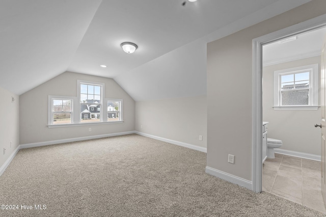 bonus room featuring light carpet and lofted ceiling