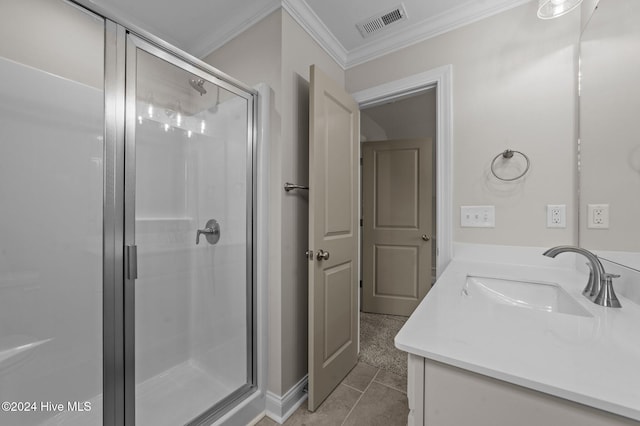 bathroom with tile patterned floors, a shower with door, vanity, and ornamental molding