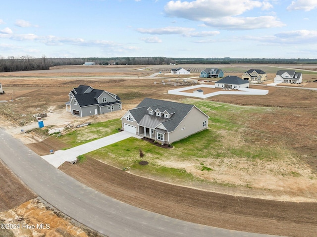 birds eye view of property with a rural view