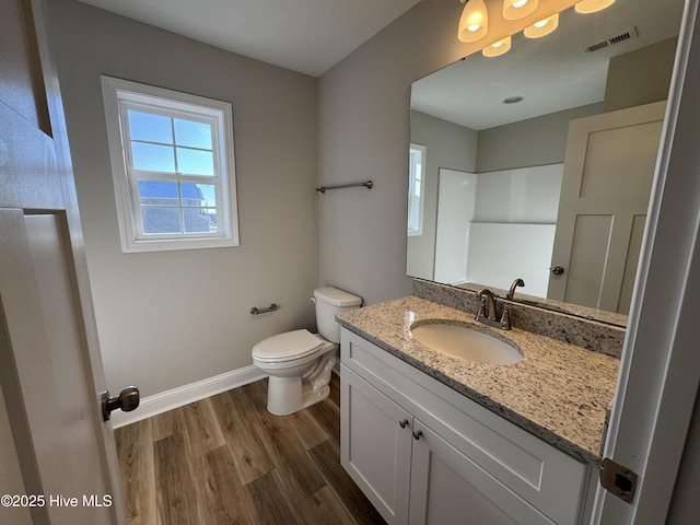 bathroom featuring hardwood / wood-style flooring, toilet, and vanity