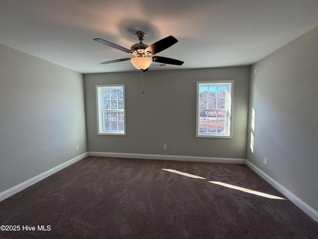 unfurnished room featuring ceiling fan and dark carpet