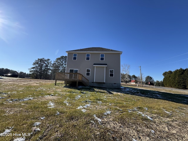 rear view of house featuring a wooden deck