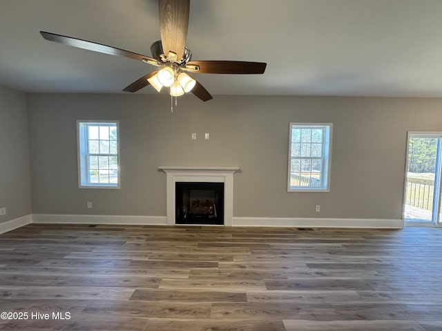 unfurnished living room with ceiling fan and wood-type flooring