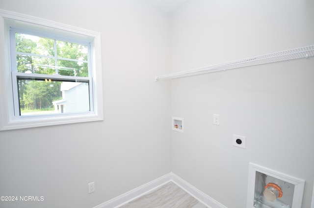 clothes washing area with baseboards, laundry area, hookup for a washing machine, and hookup for an electric dryer