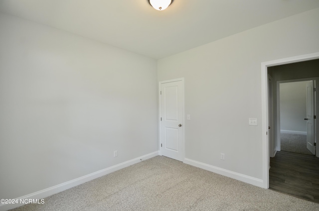 unfurnished bedroom with carpet flooring and baseboards