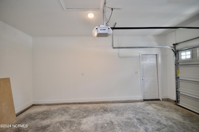 garage with baseboards and a garage door opener