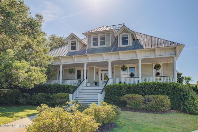 view of front of house with a porch and a front yard