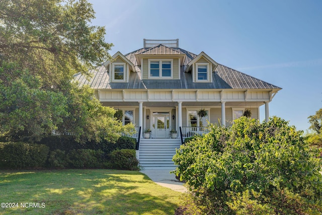 view of front facade with covered porch and a front yard