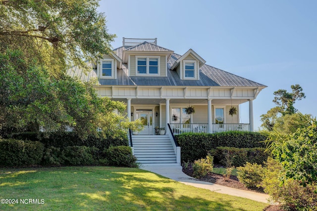 view of front of house with a porch and a front lawn