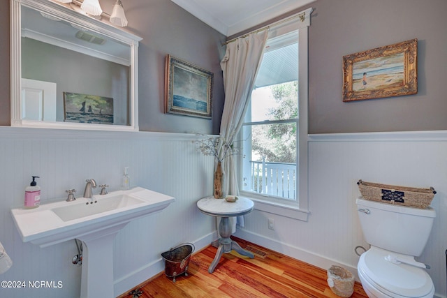 bathroom with hardwood / wood-style floors and toilet