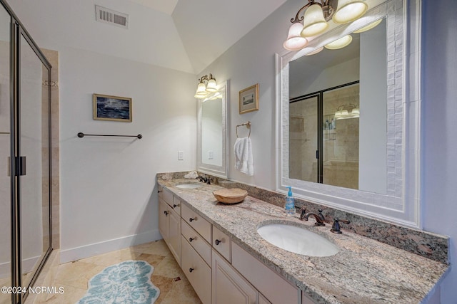 bathroom featuring tile patterned flooring, vanity, lofted ceiling, and walk in shower