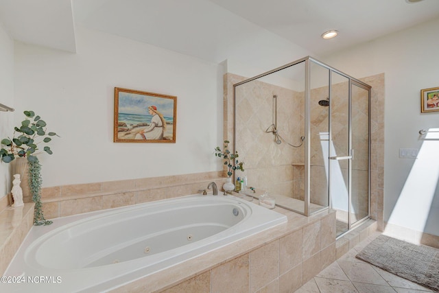 bathroom featuring tile patterned floors and separate shower and tub