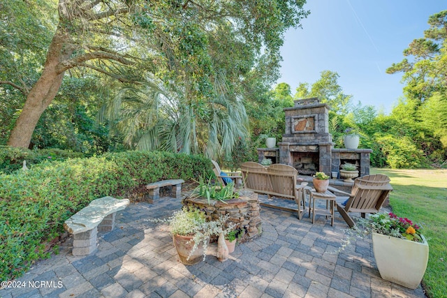 view of patio with an outdoor stone fireplace