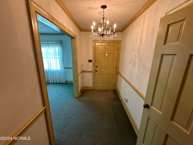 interior space featuring dark carpet, crown molding, and a notable chandelier