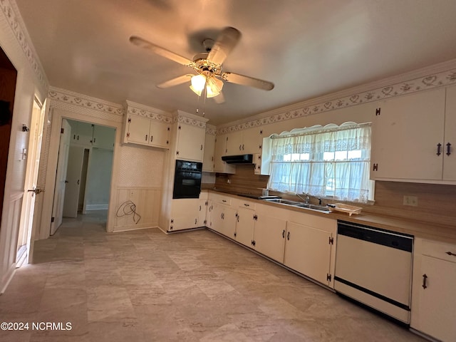 kitchen with white dishwasher, oven, white cabinets, sink, and tasteful backsplash