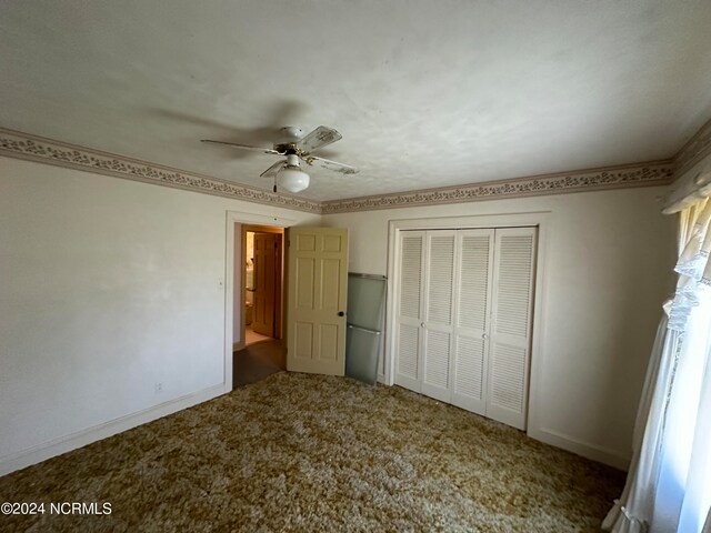 unfurnished bedroom with carpet floors, a closet, and ceiling fan