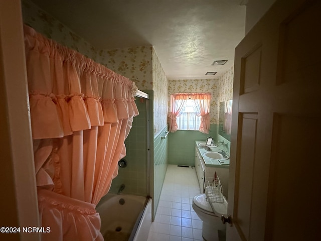 full bathroom featuring toilet, vanity, tile patterned floors, and enclosed tub / shower combo