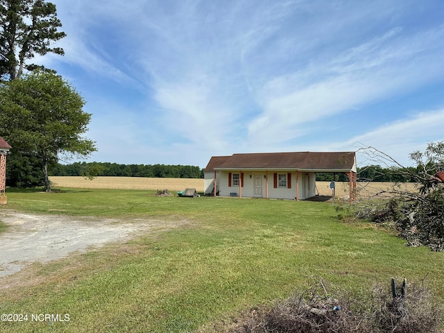 view of front of home featuring a rural view and a front lawn