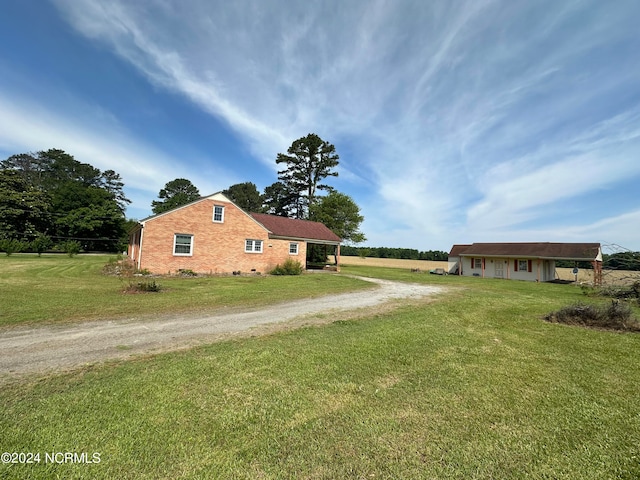 view of side of home with a lawn