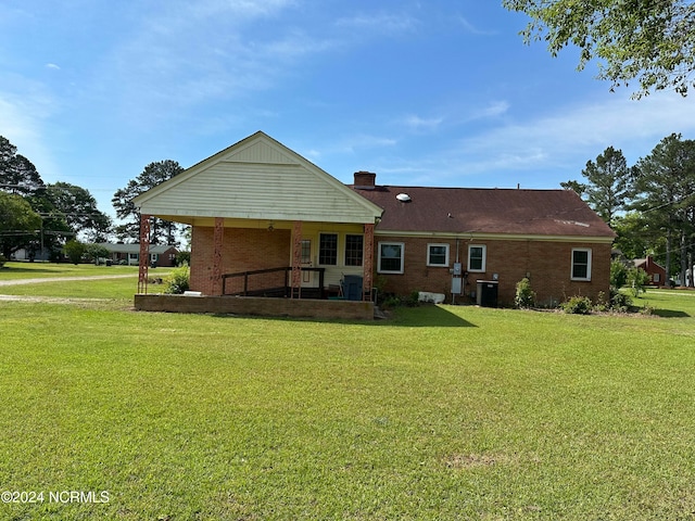 back of property featuring a yard and central AC unit