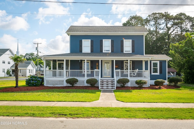 country-style home featuring covered porch and a front yard