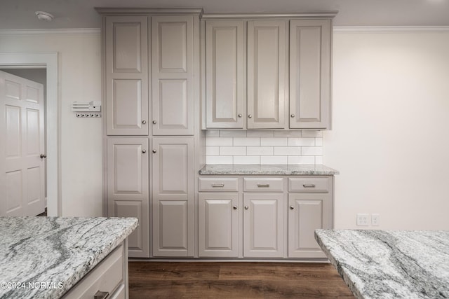 519 E Water St, Belhaven, NC 27810 - kitchen featuring ornamental molding, dark wood-style floors, backsplash, and light stone countertops